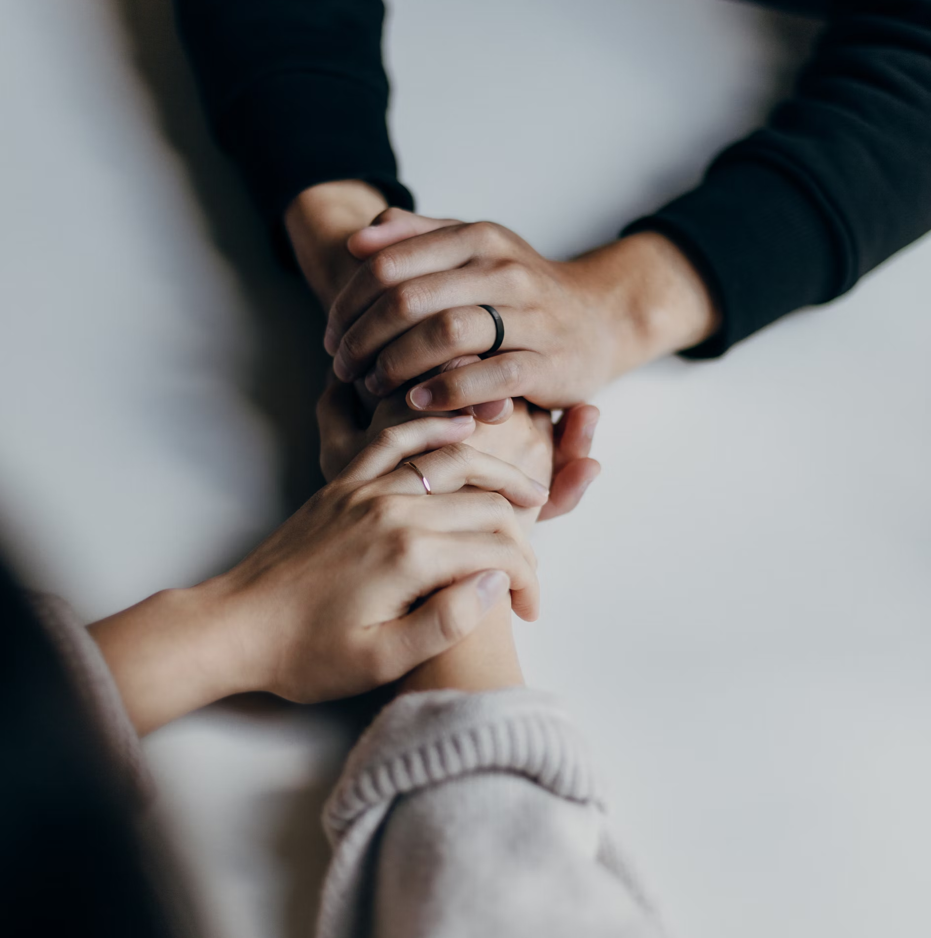 people holding hands in prayer