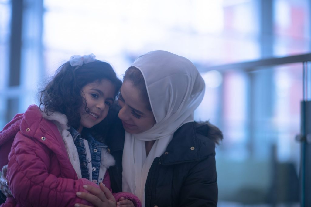 Muslim Mother and Daughter in the Airport stock photo