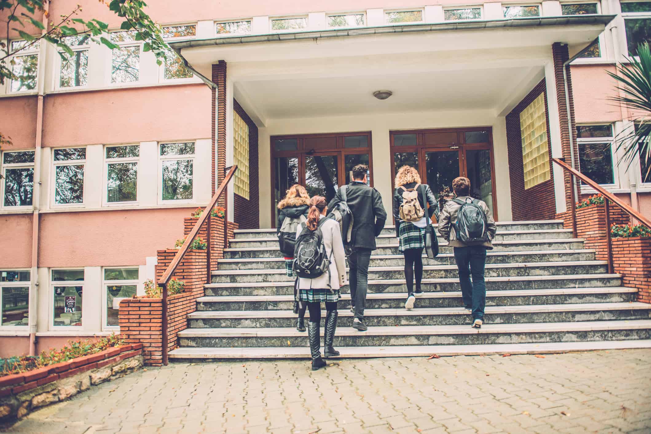 Five Turkish students walking to school. They are ascending the staircase, outdoors, campus. Cold autumnal morning. Nikon D800, full frame, XXXL.