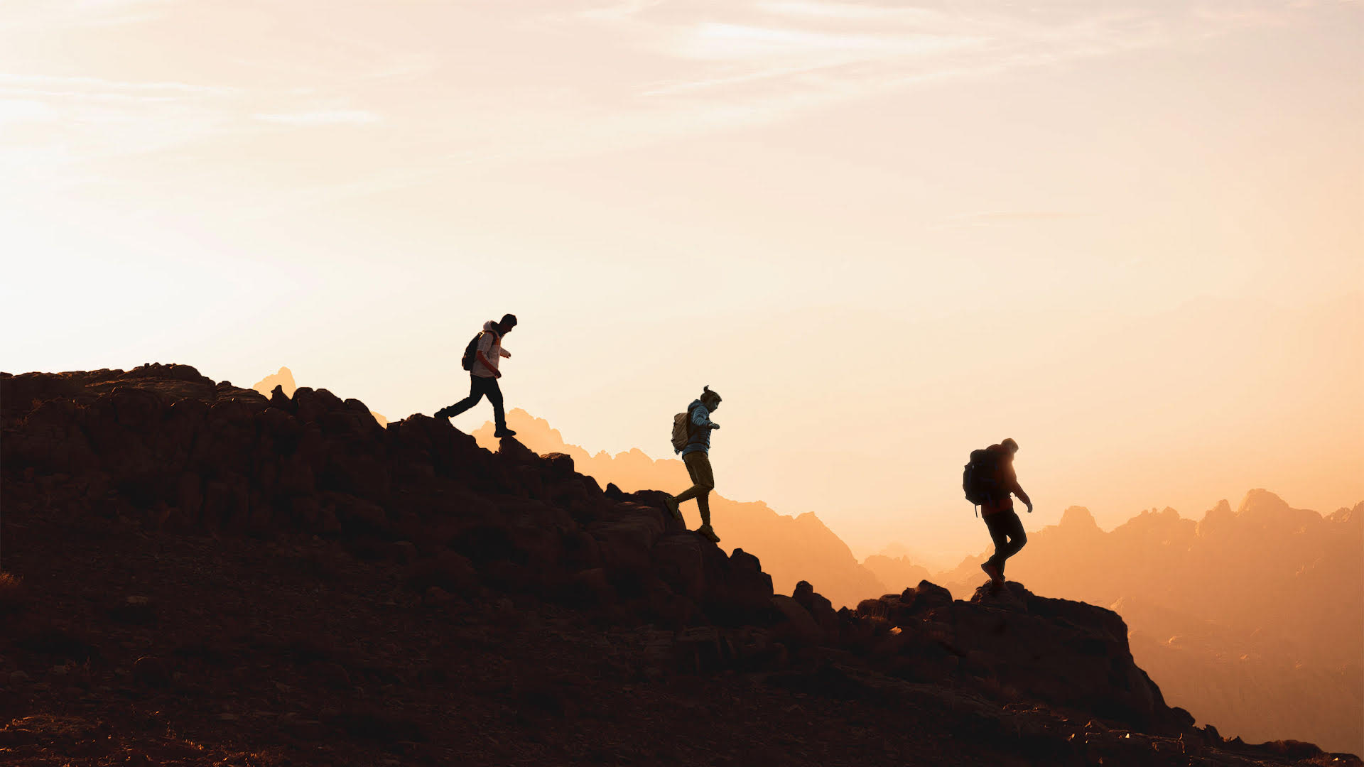 Silhoutte of people walking on mountain